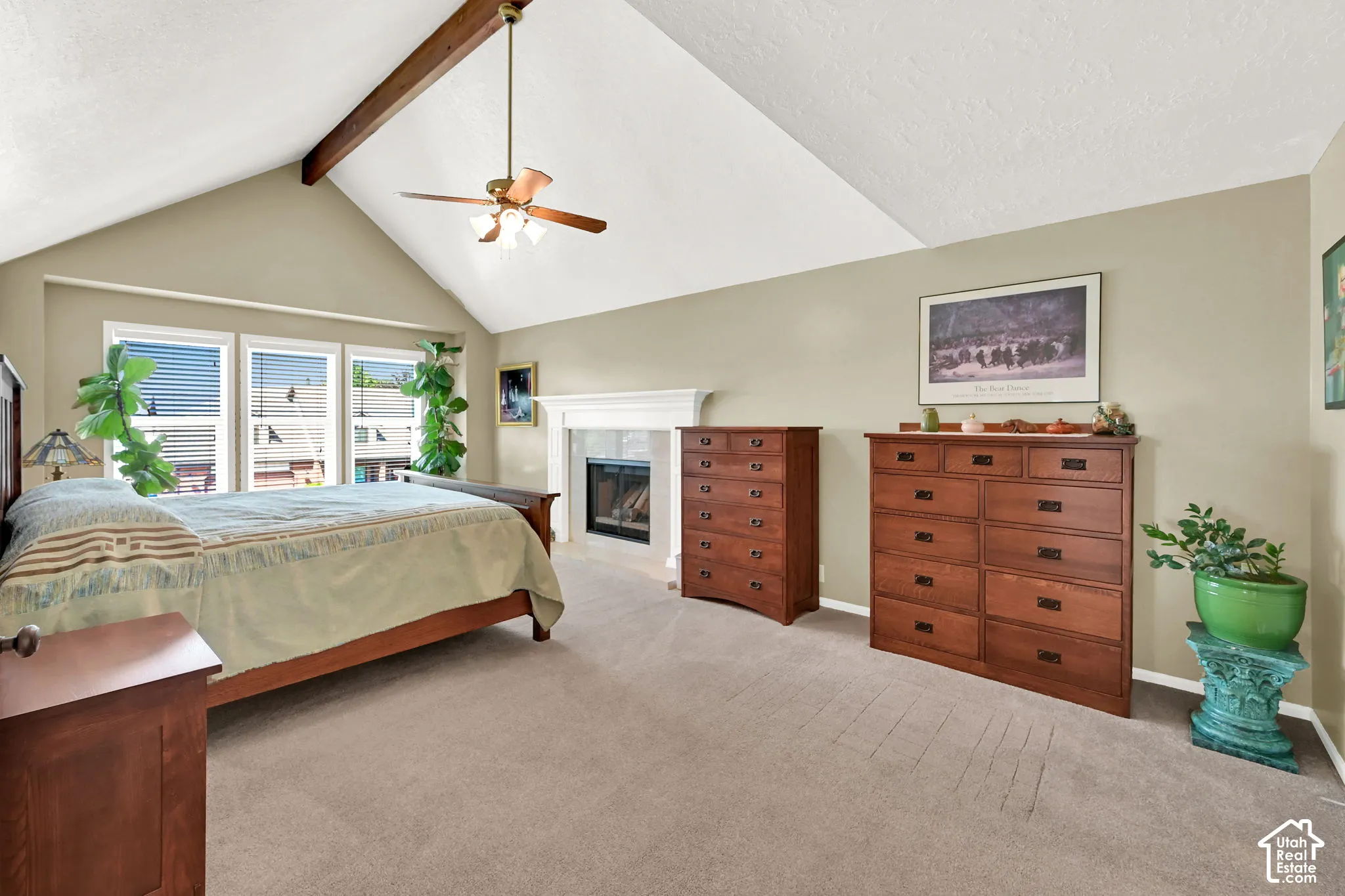 Spacious primary bedroom suite with vaulted ceilings and ceiling fan