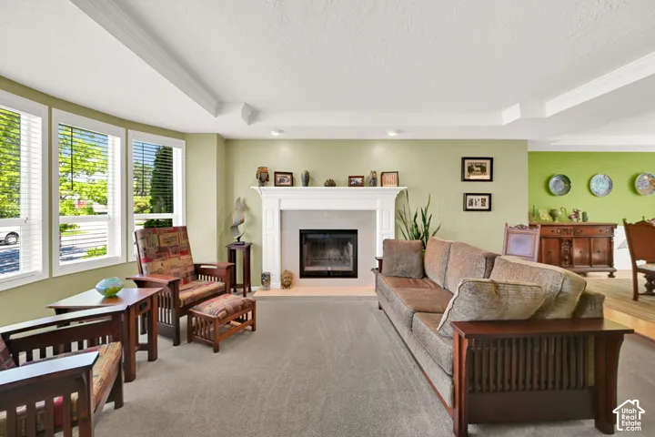 Living space featuring a white mantel fireplace and wall of windows