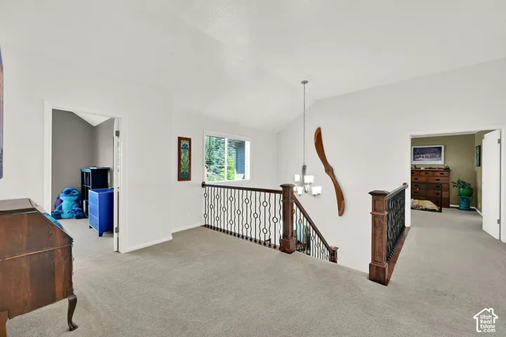 Spacious upper-level landing featuring neutral carpeting, and abundant natural light from multiple windows