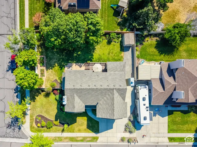Aerial perspective showcasing a residential property with a spacious backyard