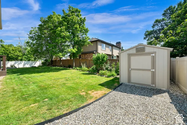 Spacious backyard featuring a storage shed
