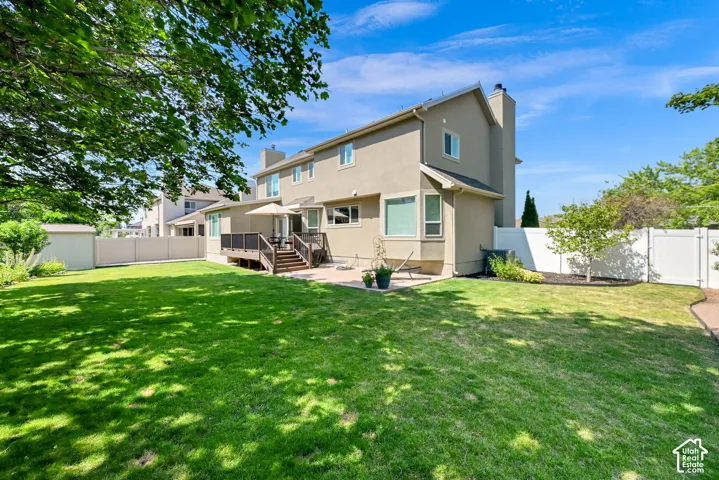 Spacious backyard featuring a manicured lawn