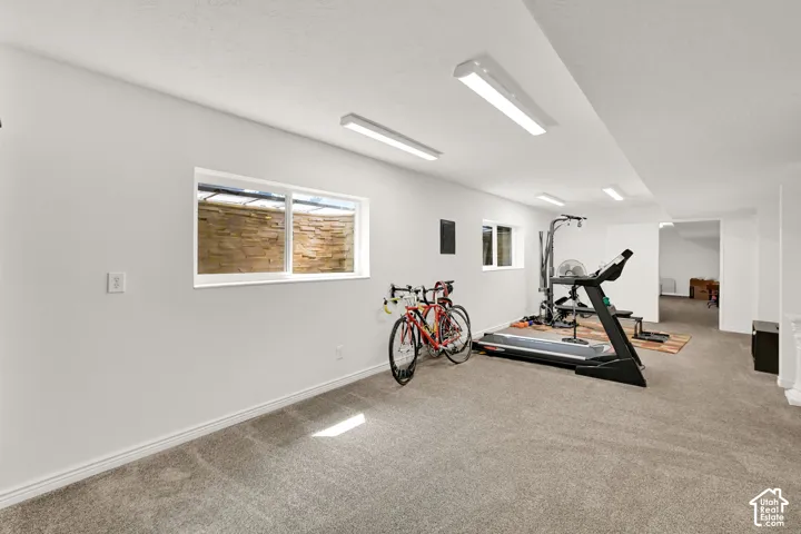 Spacious lower-level family room currently used as an exercise room.