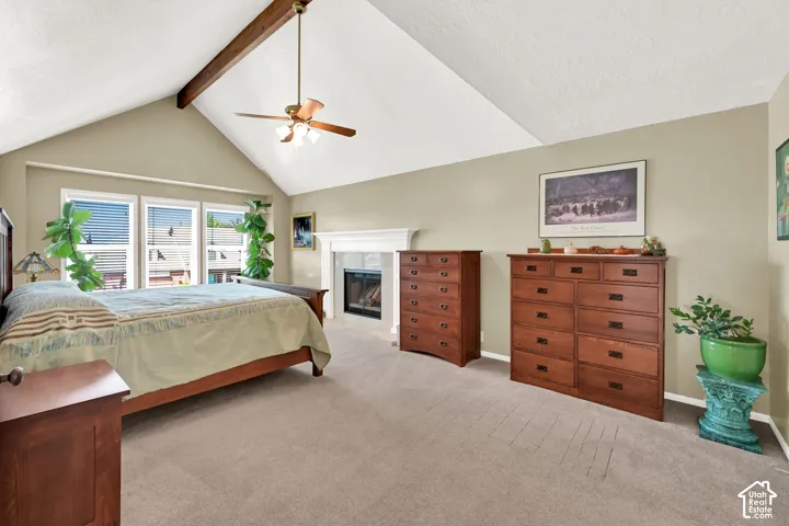 Spacious primary bedroom suite with vaulted ceilings and ceiling fan