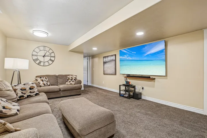 Carpeted living space with recessed lighting and a ceiling-mounted light fixture
