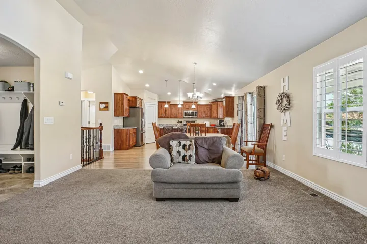 Open-concept living space featuring a generous great room with recessed lighting and vaulted ceiling