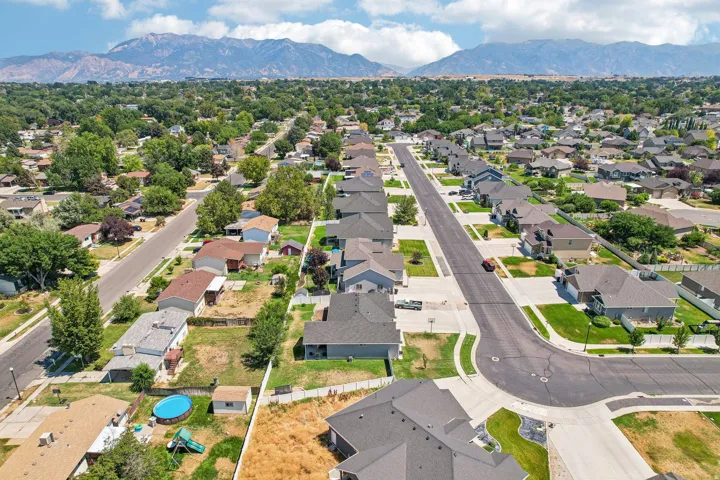 Aerial view of this new construction home situated on a tree-lined street in an established suburban community