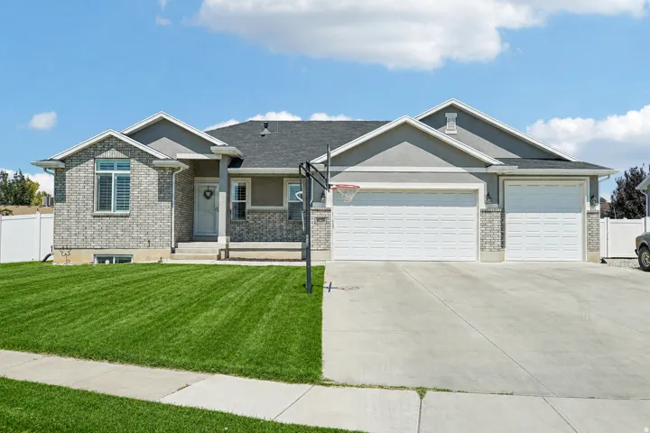 Light gray brick and stucco exterior with white trim