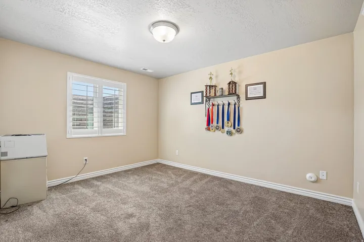 Room featuring light-toned wall paint, white trim, and a textured ceiling