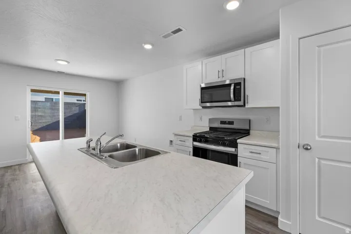 Kitchen island featuring a double-basin stainless steel sink with a chrome faucet