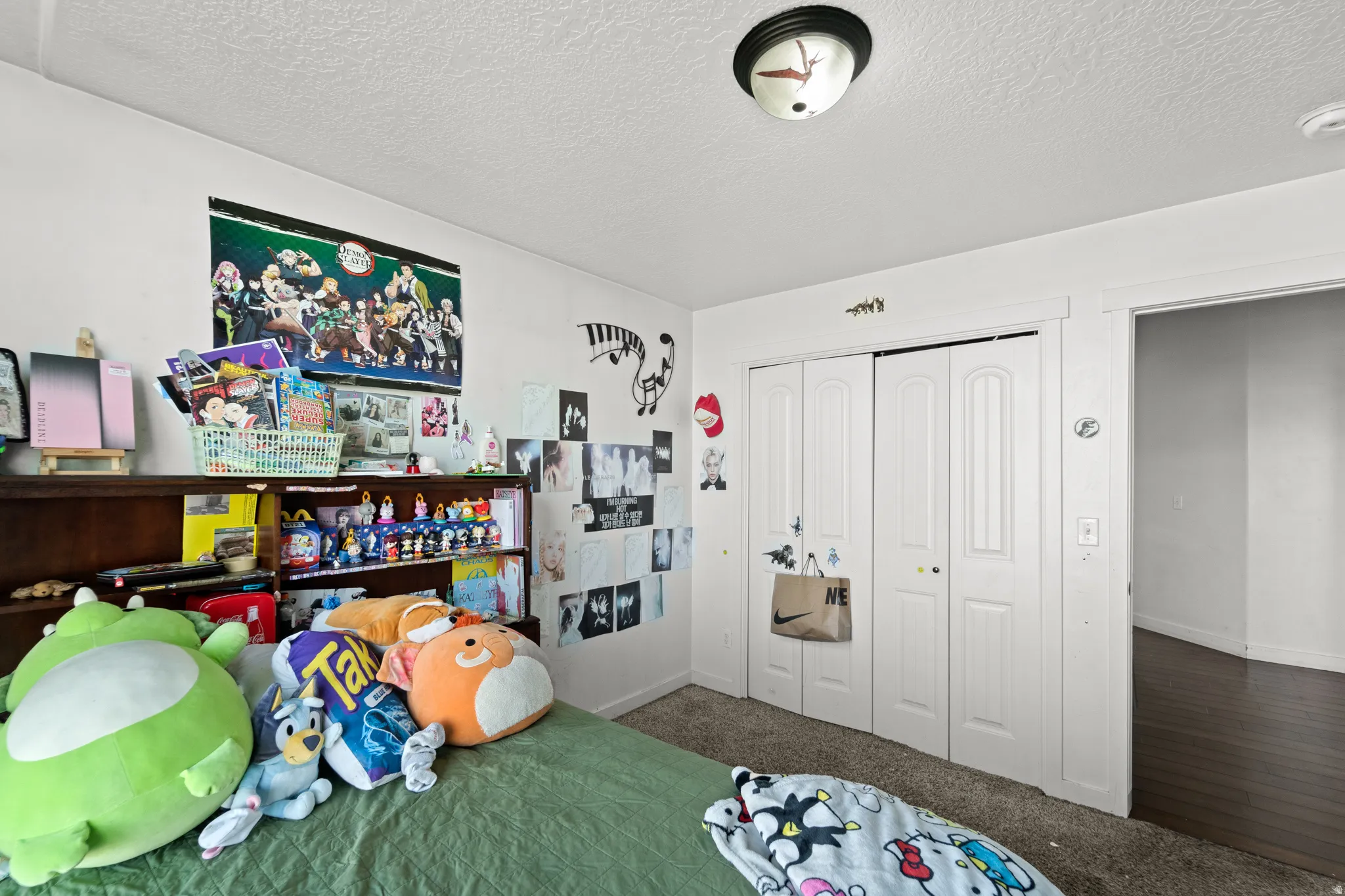 White walls and textured ceiling with a flush-mount light fixture