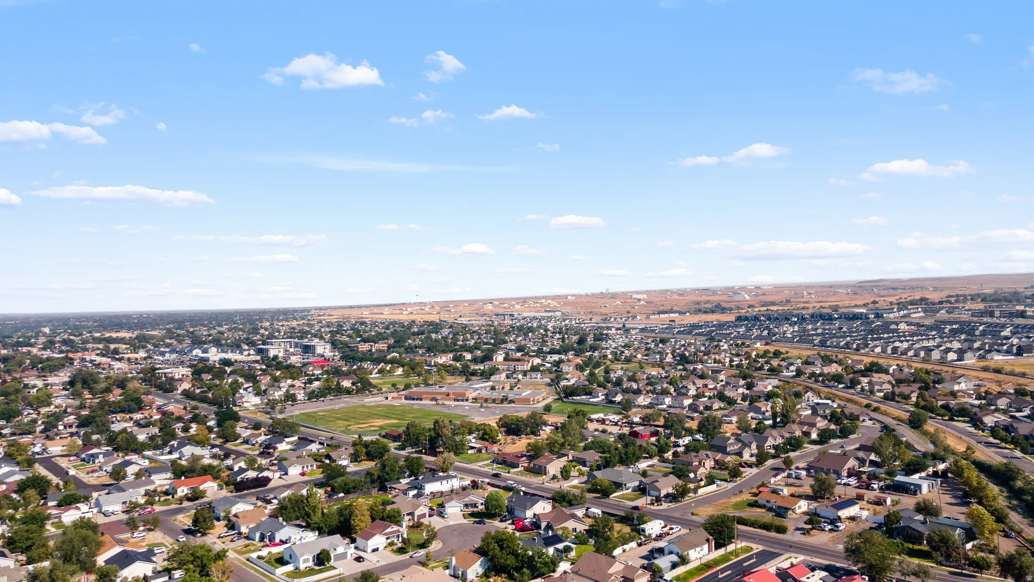 Expansive aerial showcasing a residential neighborhood with varied housing styles