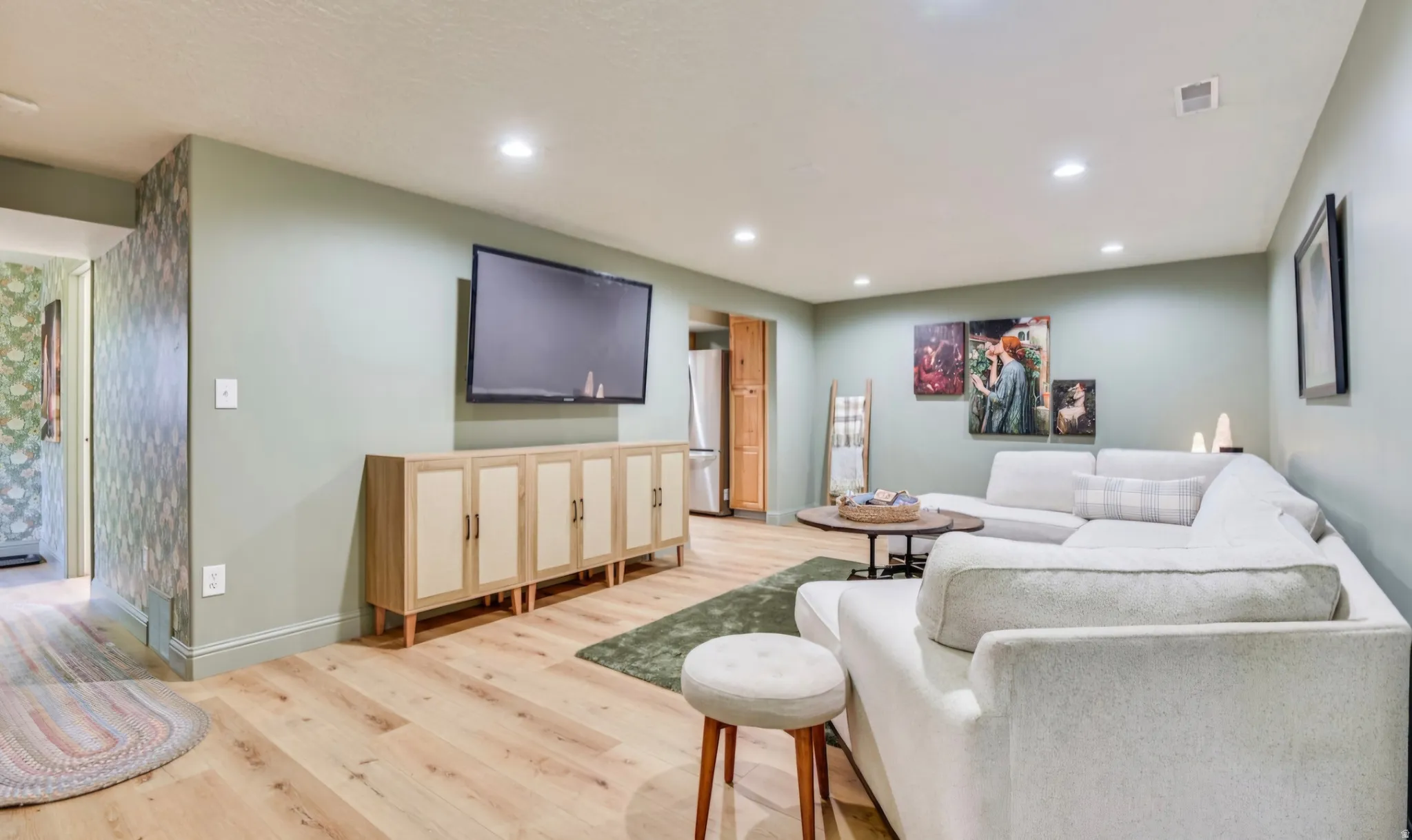 Spacious interior featuring wide plank wood-finish flooring, recessed lighting, and a neutral wall color