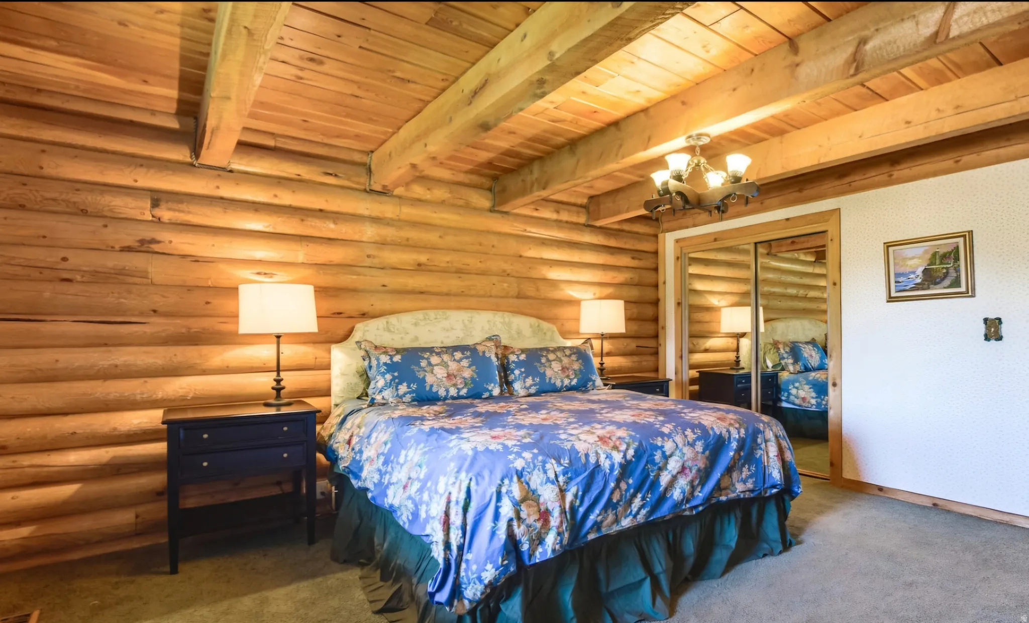 Interior room featuring wood log walls and a wood-beamed ceiling