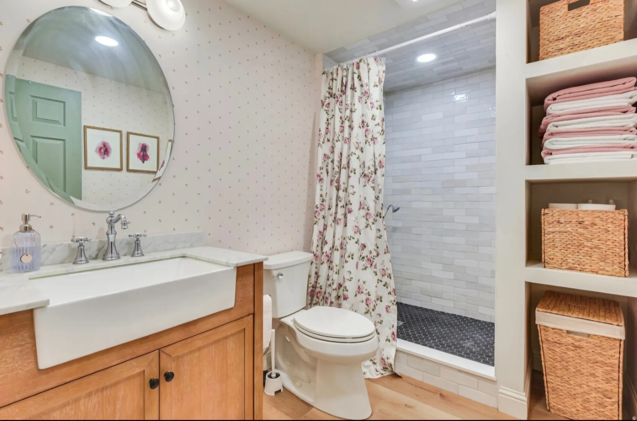 Bathroom with a farmhouse-style sink, white countertop, and wood-finish vanity