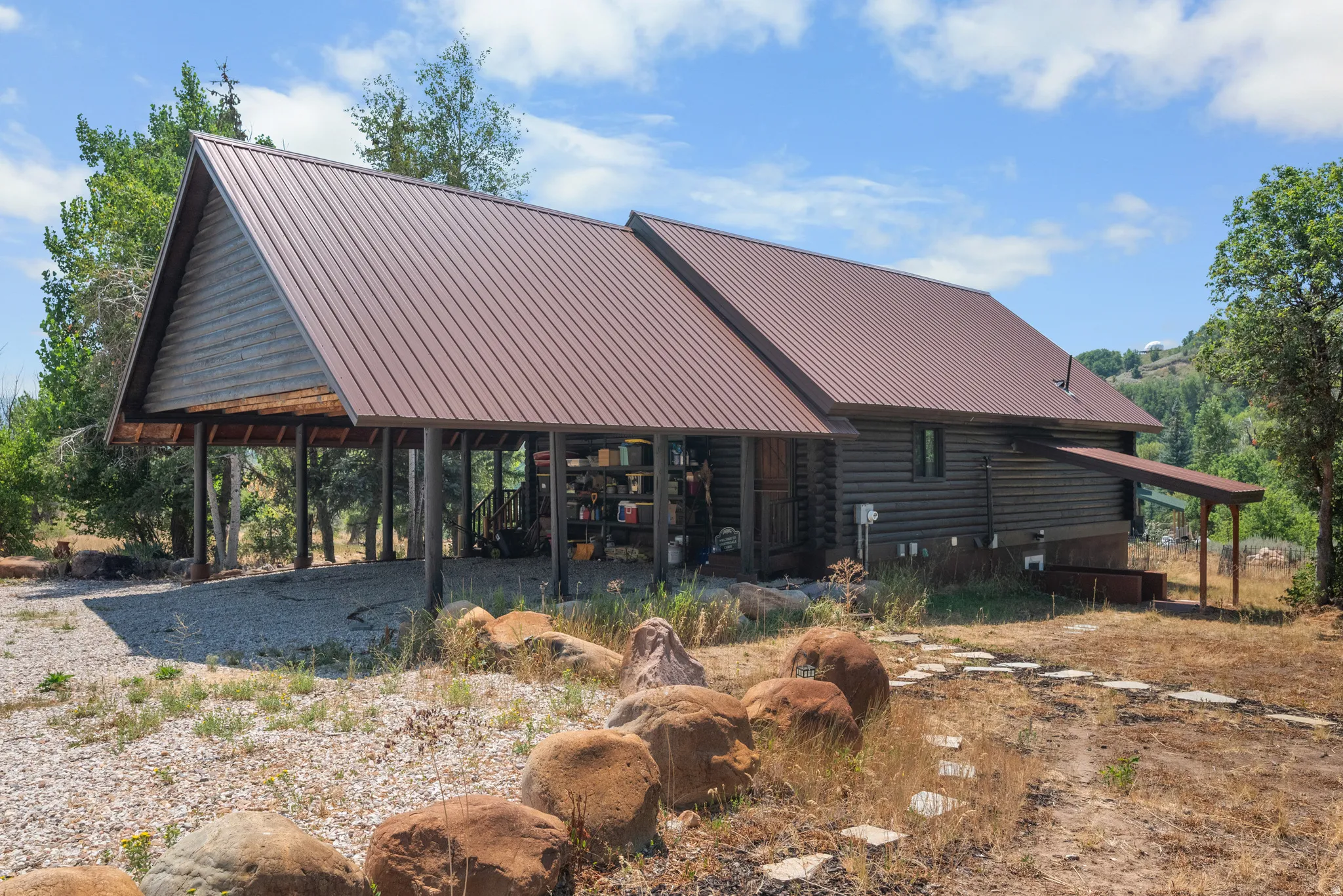 Log cabin exterior with a brown metal roof