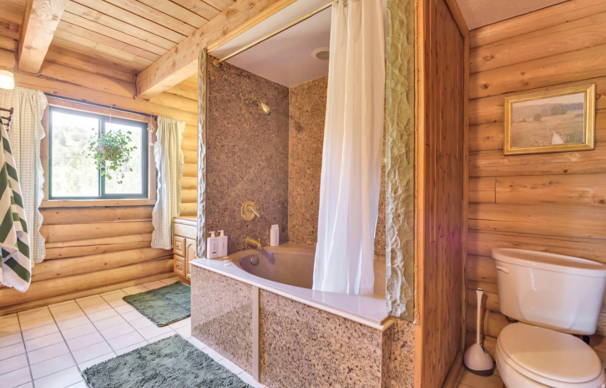 Bathroom featuring log walls, exposed beam ceiling, tiled flooring, and a bathtub with stone-finish surround and wall panels