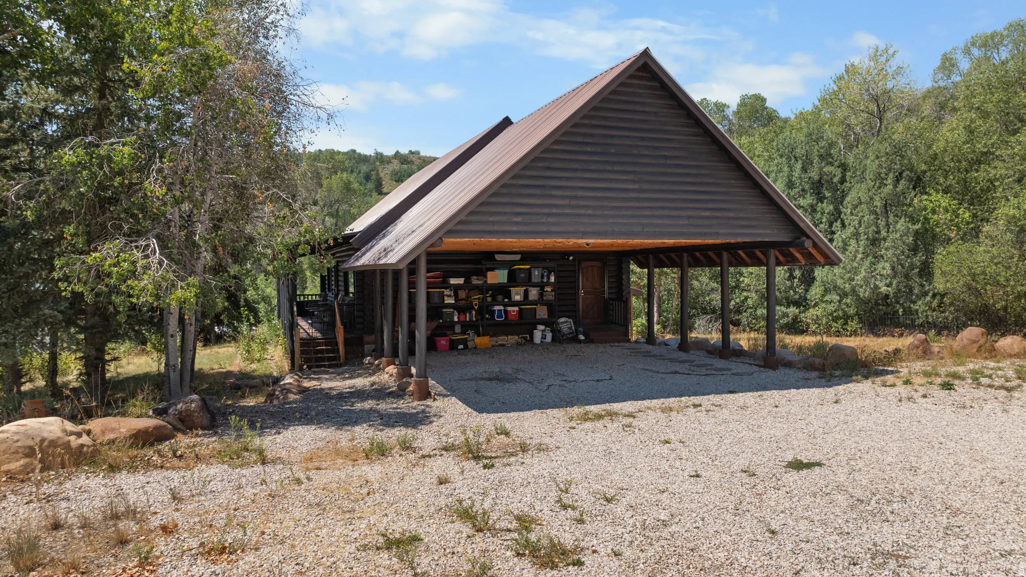 Wood-sided building with a metal roof and an integrated carport