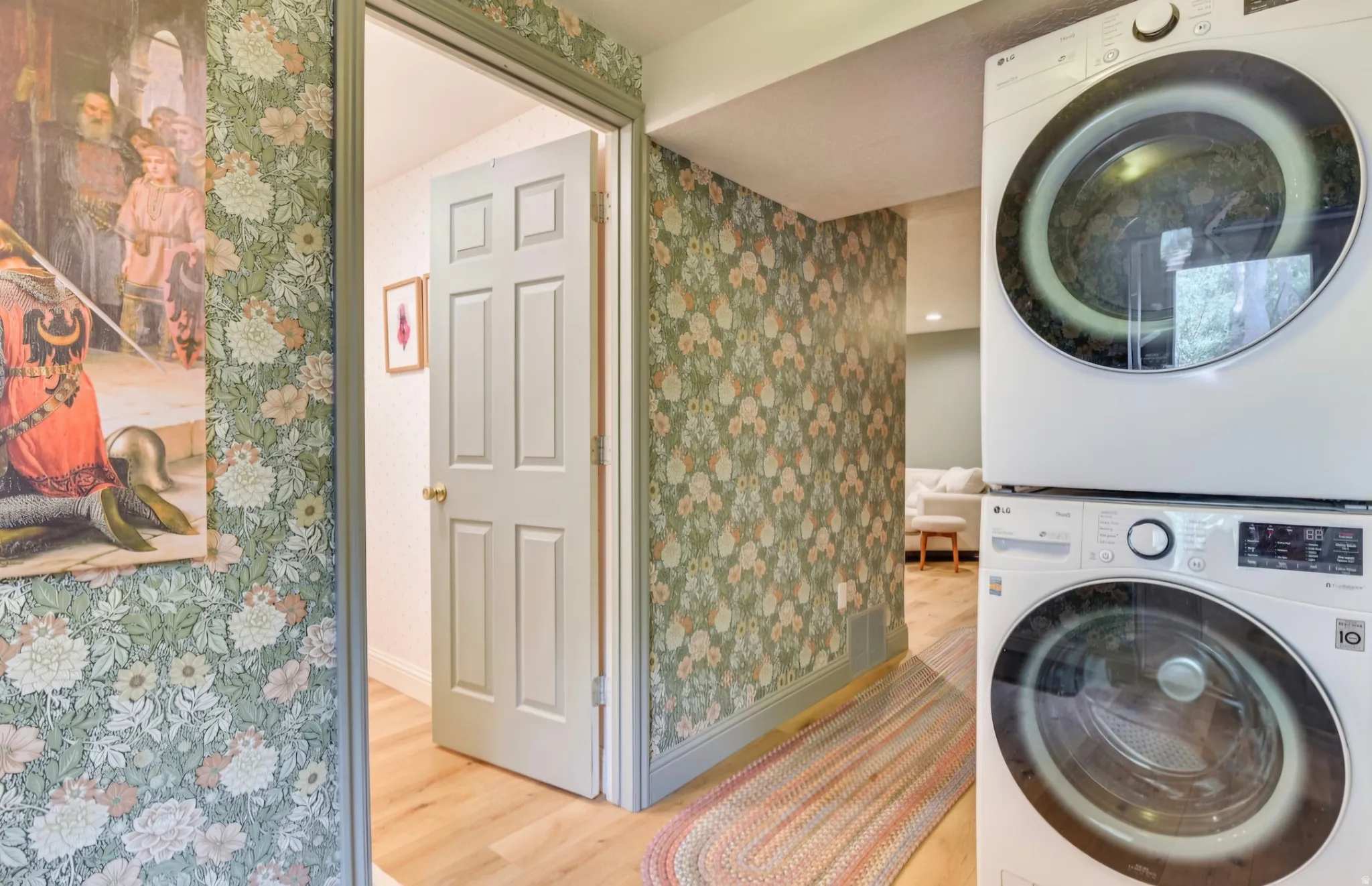 Dedicated laundry area featuring a stacked washer and dryer unit