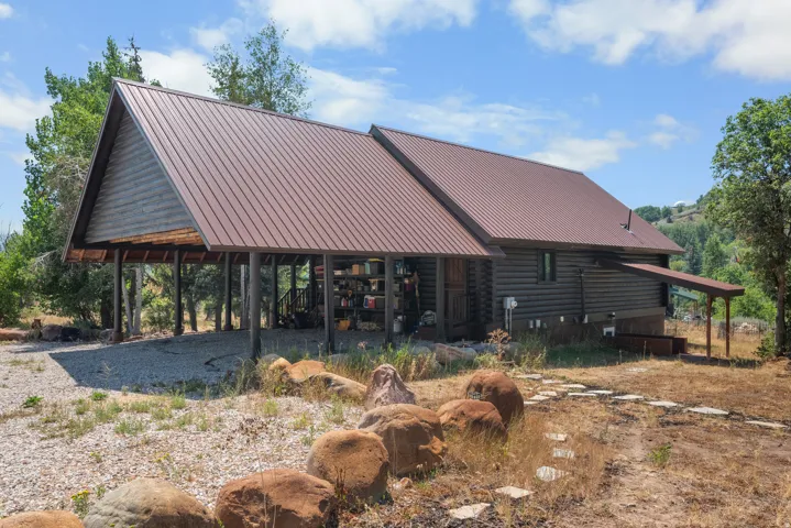 Log cabin exterior with a brown metal roof