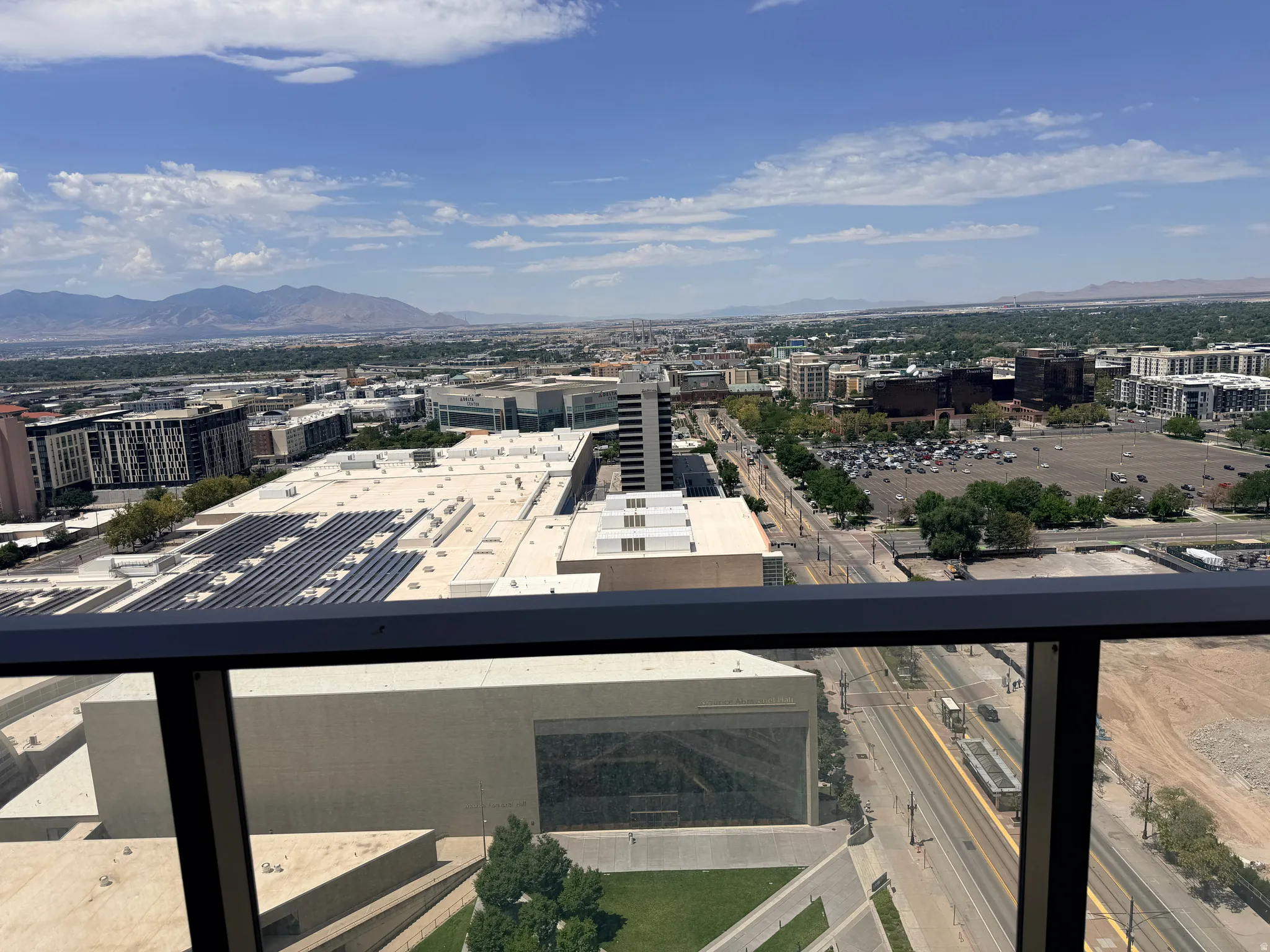 Expansive high-rise vantage overlooking the urban landscape and surrounding valley
