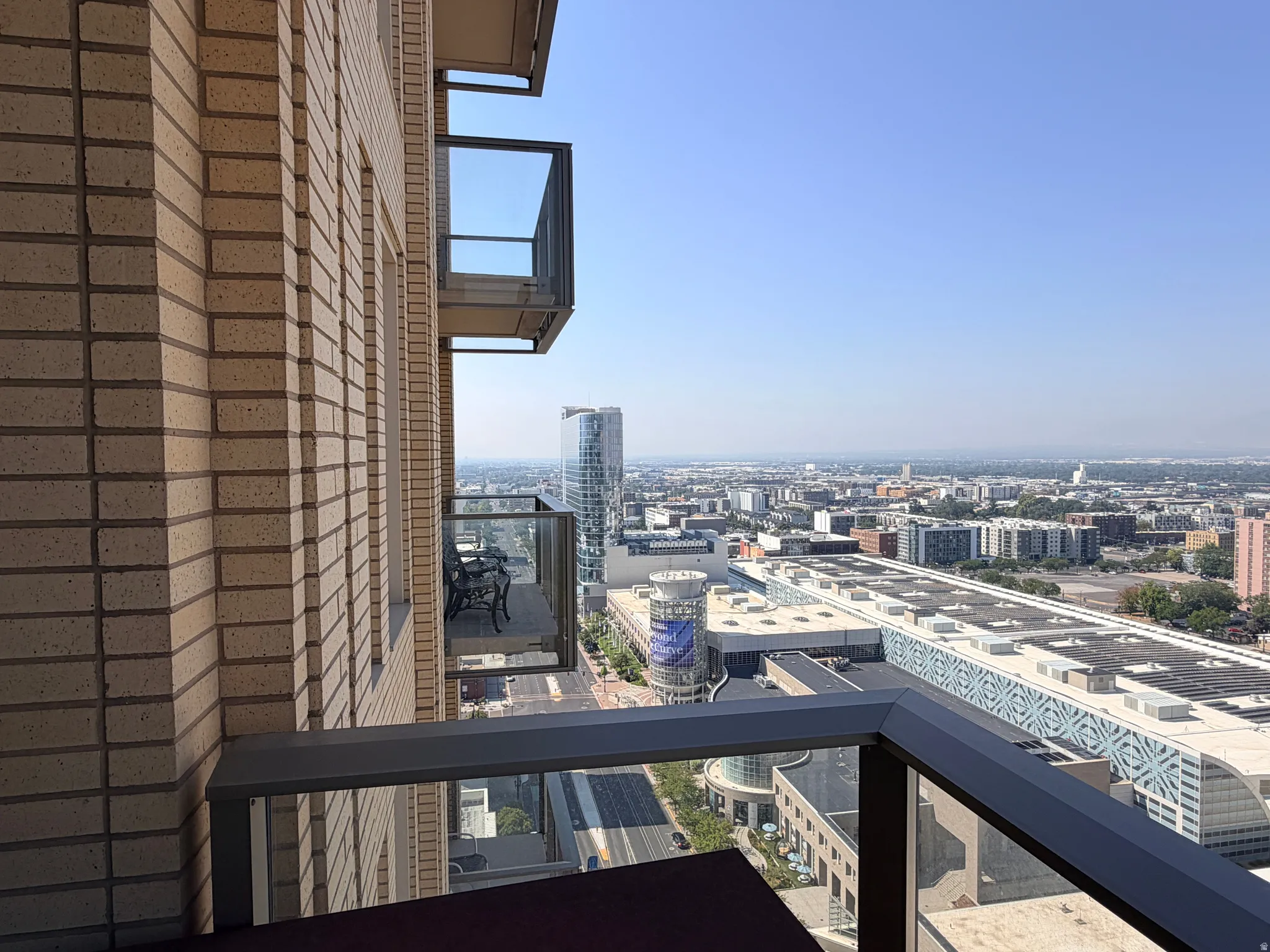 Balcony featuring dark metal railings with glass panels