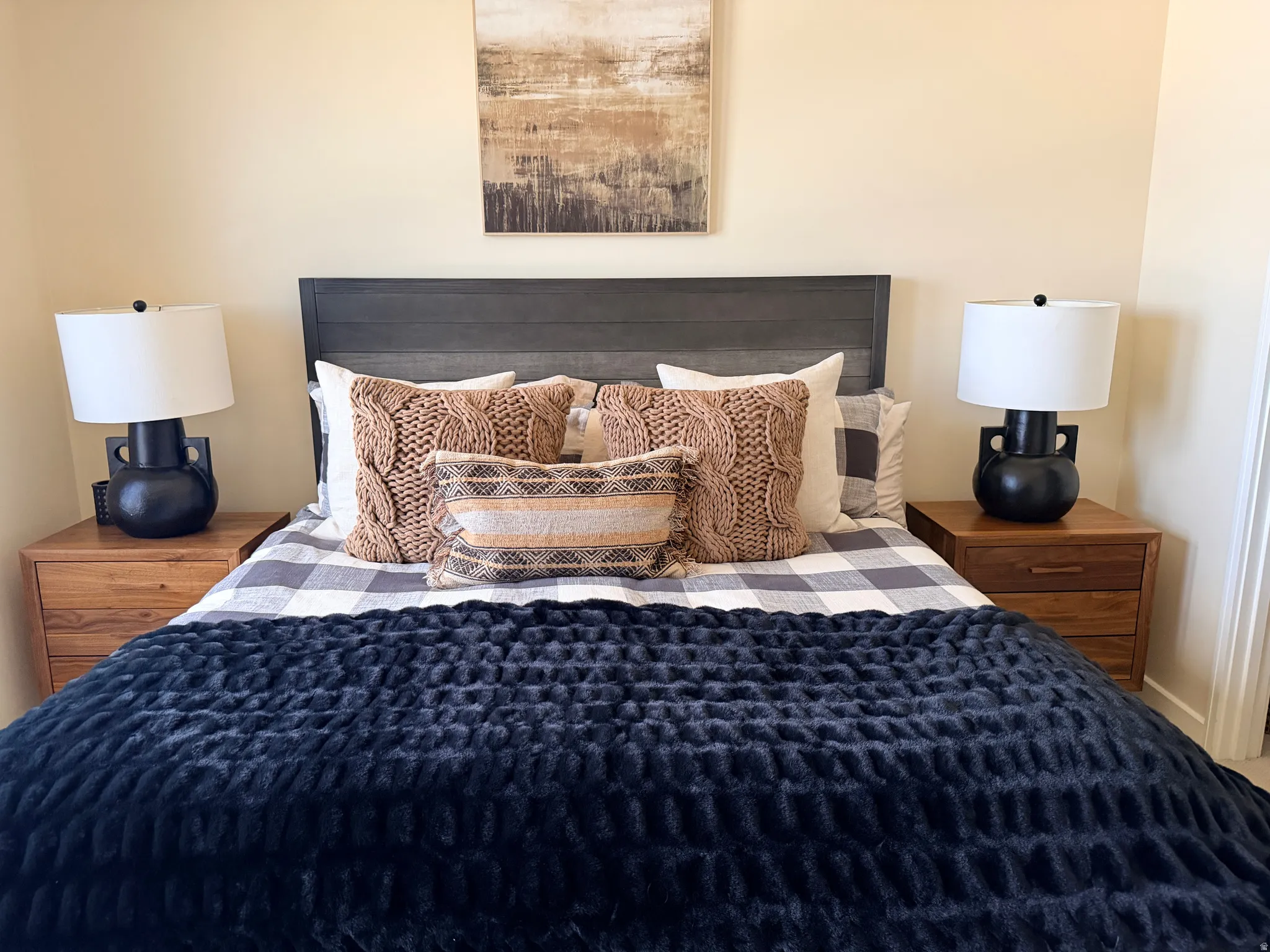 Wood-panel headboard framing the bed, flanked by matching wood-finish nightstands