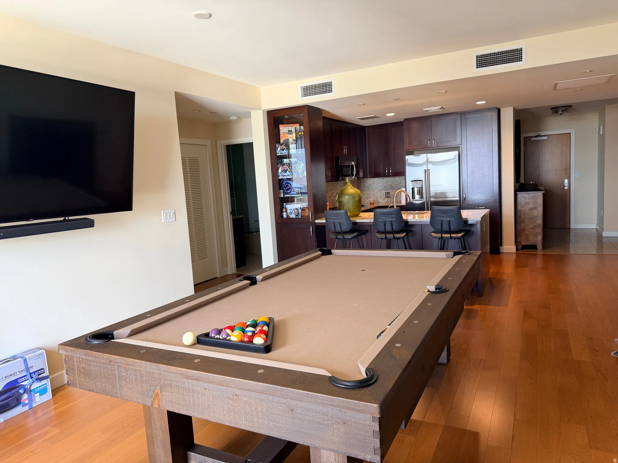 Open-concept living space featuring wood-finish flooring throughout