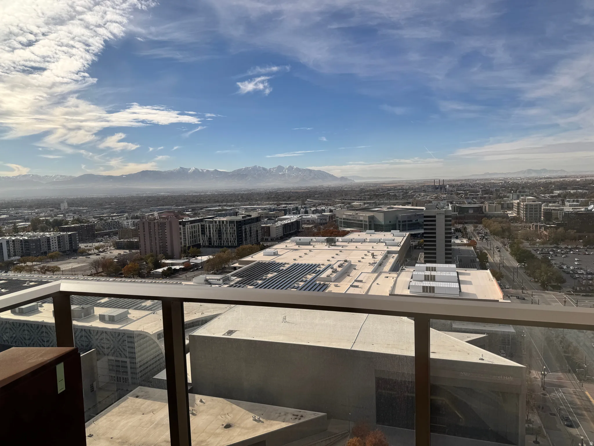 Expansive urban landscape with distant mountains under a clear sky
