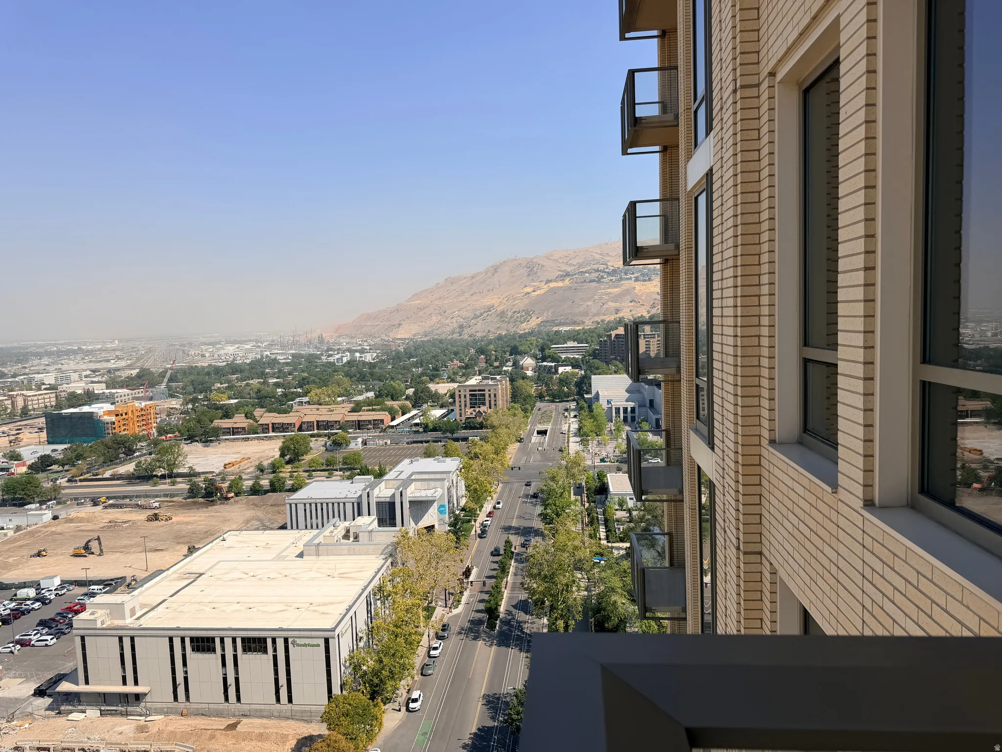 Contemporary high-rise architecture featuring a brick facade with multiple windows and individual balconies