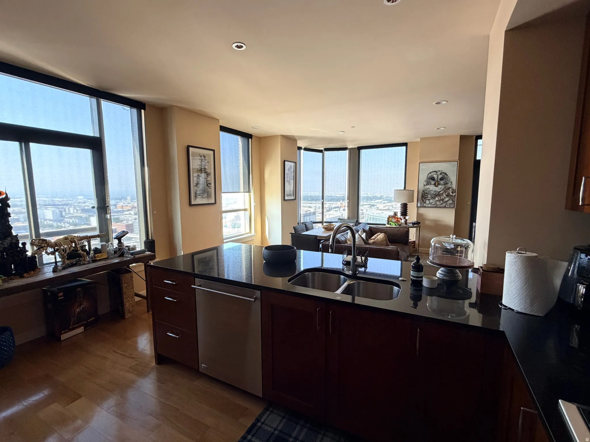 Modern kitchen island featuring a double stainless steel sink, black countertop, and integrated dishwasher
