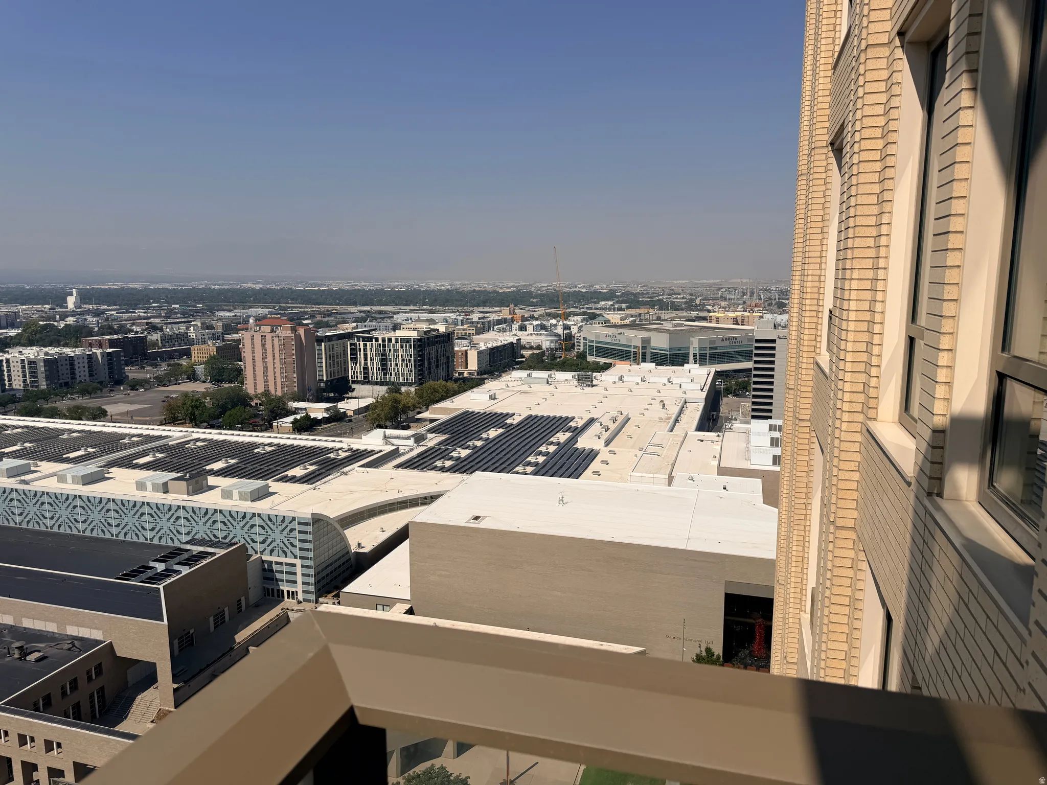 Elevated vantage point showcasing expansive rooftop terrace with finished surface and open-air space