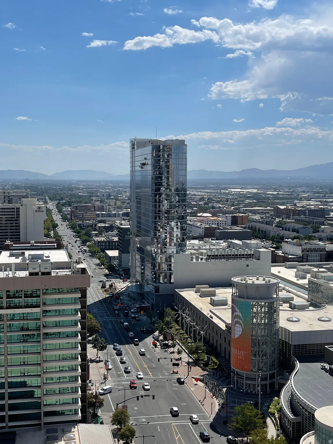 Urban high-rise featuring prominent architectural detailing and glass facade with expansive city vistas