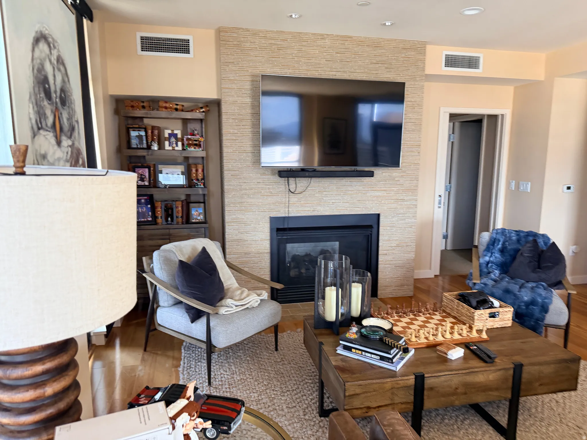 Stacked stone-style fireplace surround with a dark firebox and hearth