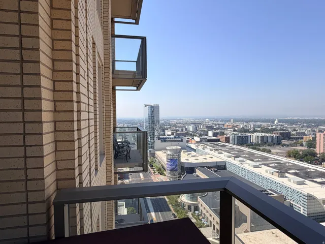 Balcony featuring dark metal railings with glass panels
