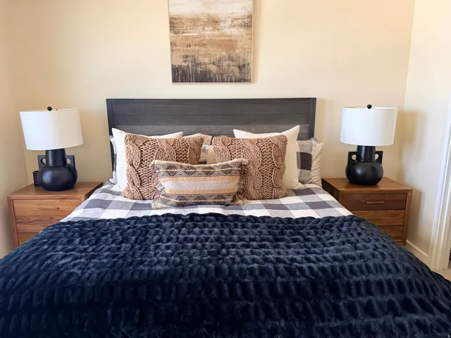 Wood-panel headboard framing the bed, flanked by matching wood-finish nightstands