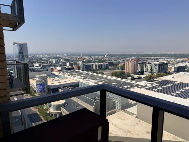 Expansive city skyline and distant landscape views from a glass-paneled balcony