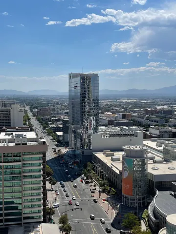 Urban high-rise featuring prominent architectural detailing and glass facade with expansive city vistas