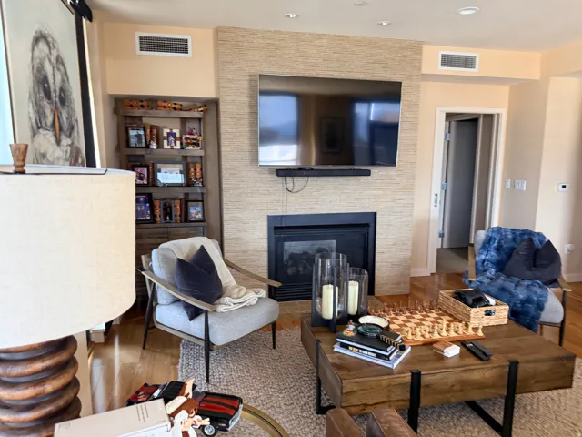 Stacked stone-style fireplace surround with a dark firebox and hearth