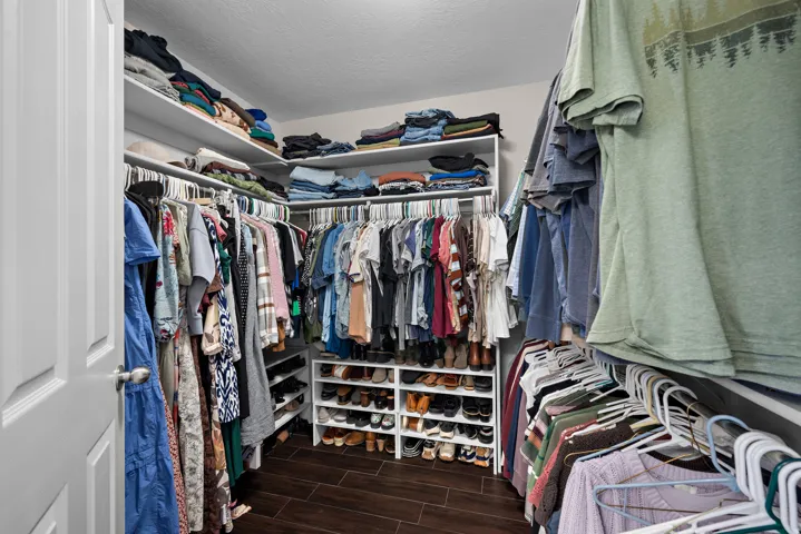 Primary bedroom walk-in closet