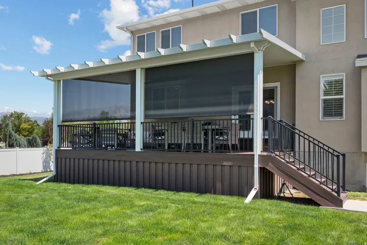 Covered deck featuring Trex decking and a roll-down shade system