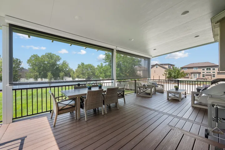 Covered deck featuring Trex decking and a roll-down shade system