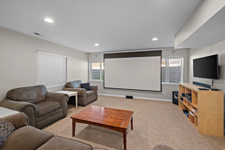 Theater area, including projector, retractable projection screen and black out shades