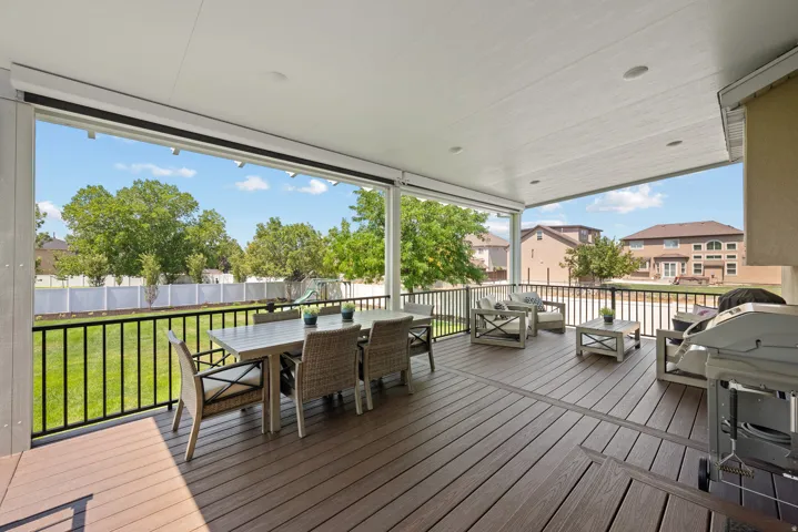 Covered deck featuring Trex decking and a roll-down shade system