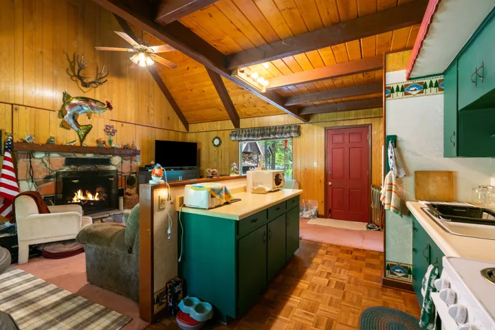 Vaulted wood-paneled ceilings with exposed beams and a ceiling fan