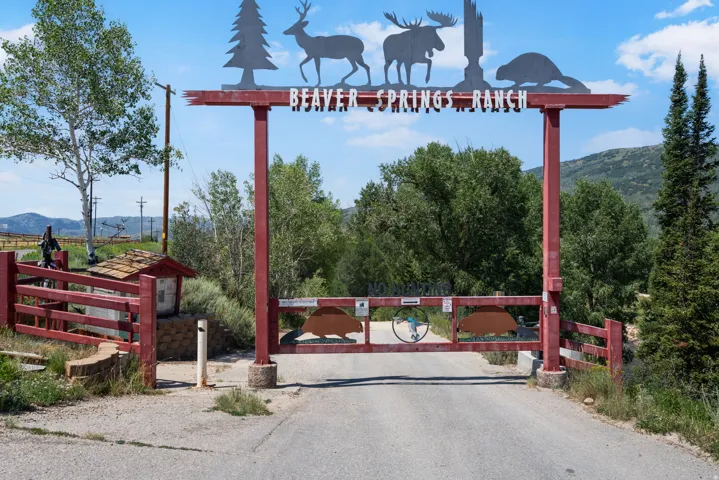 Gated entrance featuring a red wood-finish archway with decorative metal cutouts