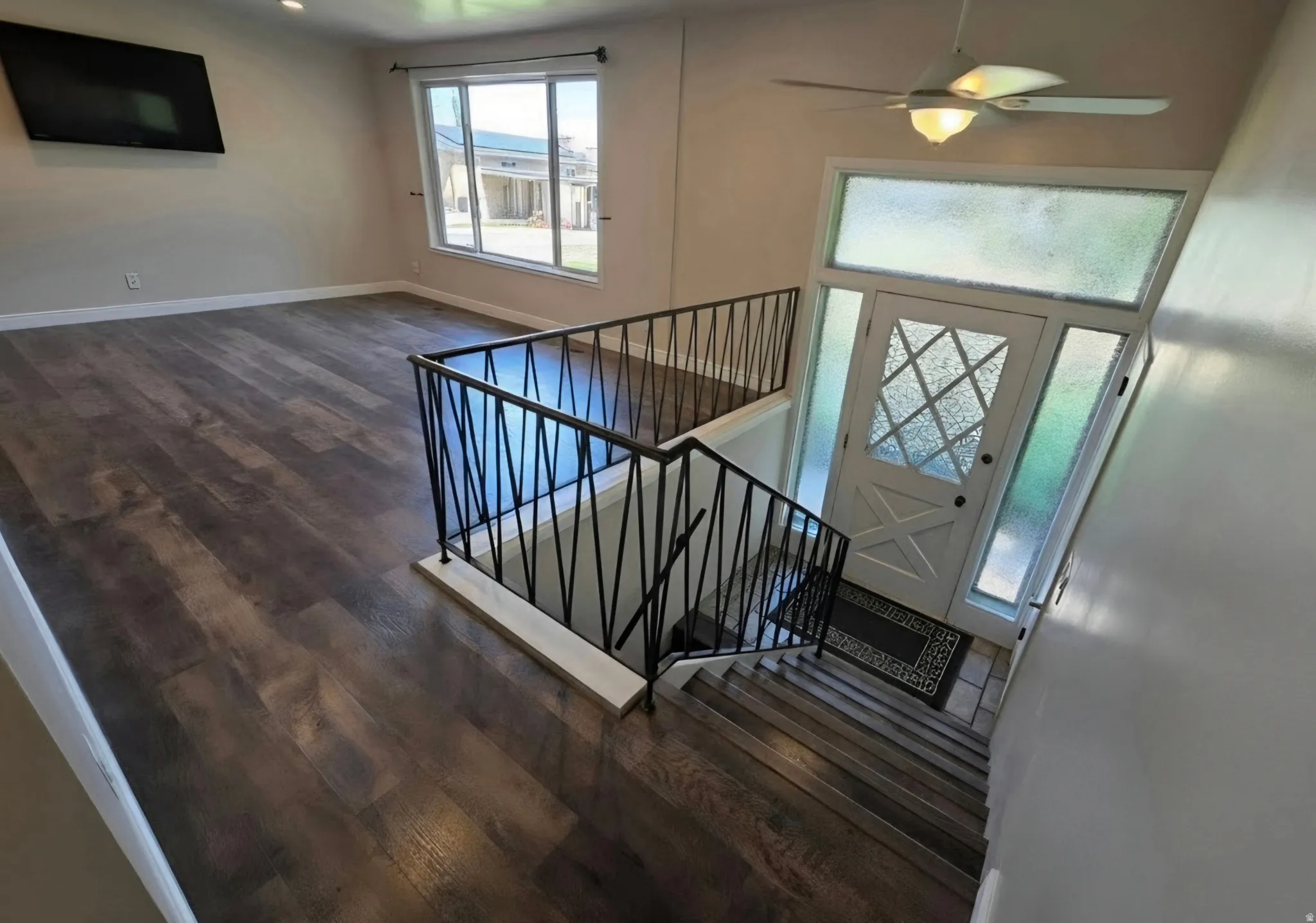 Entryway featuring a white door with decorative glass, transom window, and side lights