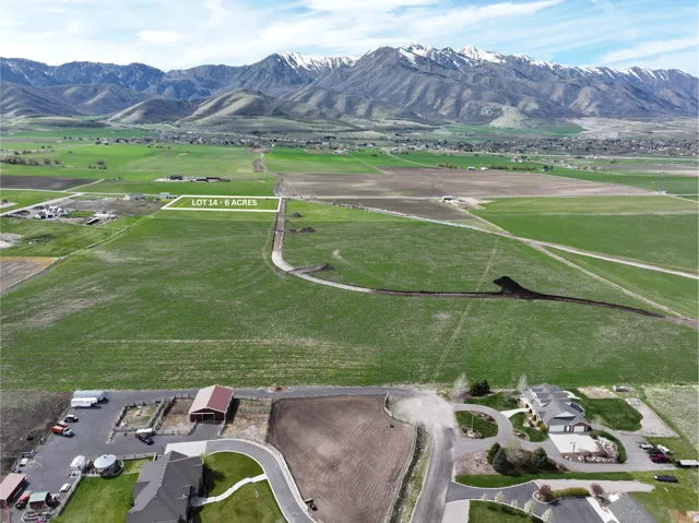 Expansive undeveloped land featuring 6 acres, mountain backdrop, and surrounding green fields