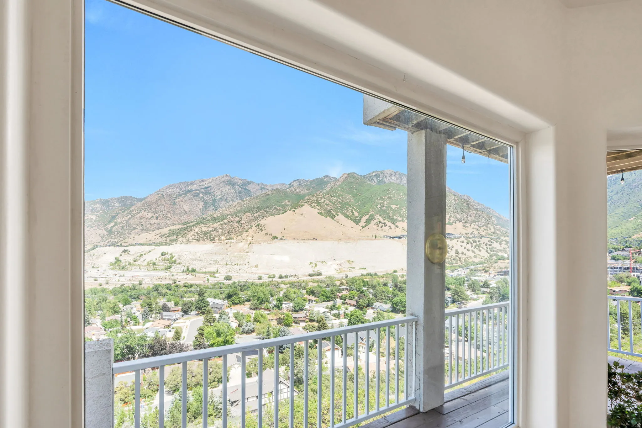 Floor-to-ceiling windows offering extensive mountain and valley scenery
