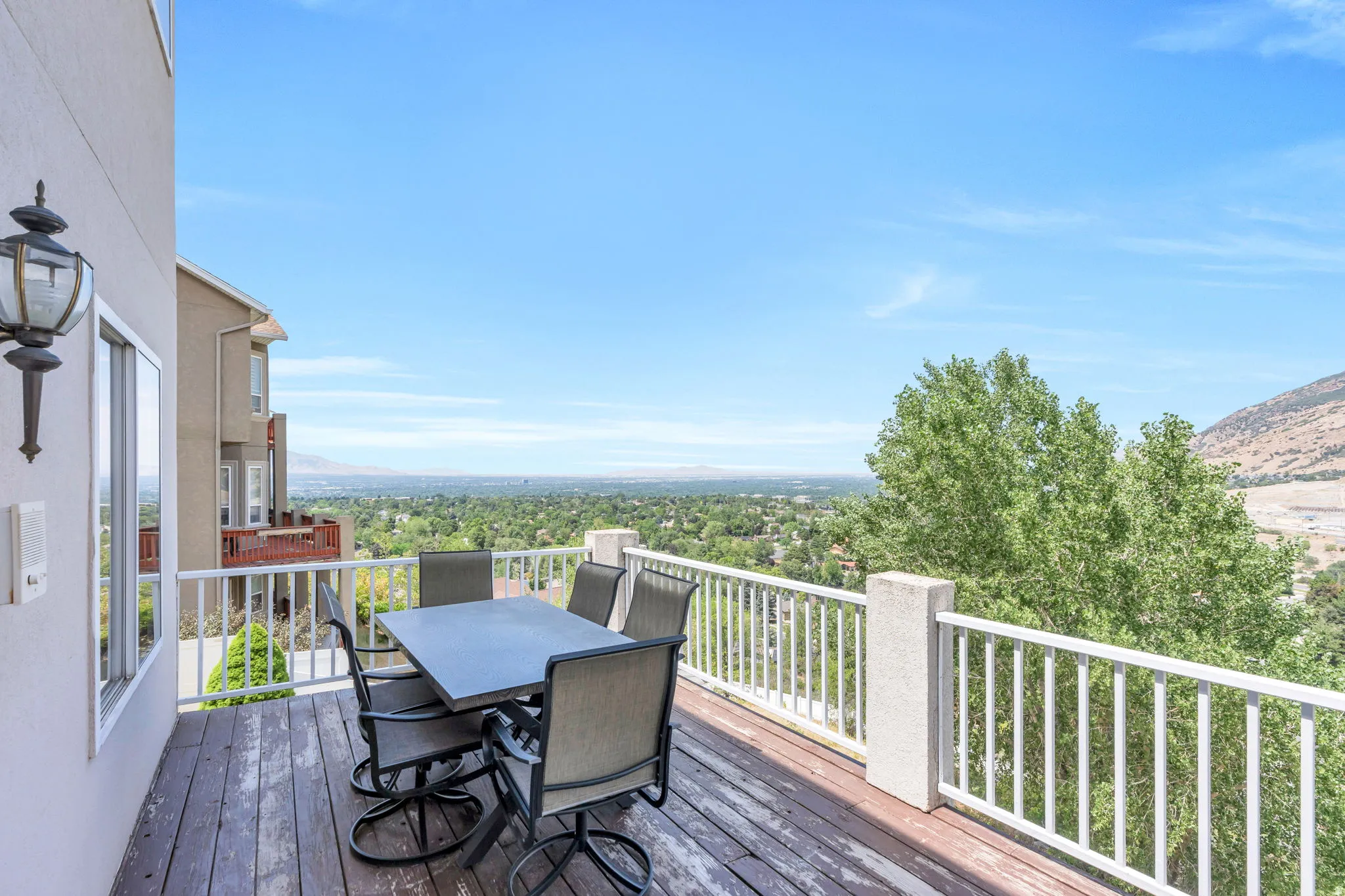 Outdoor deck featuring wood-finish flooring and white railings